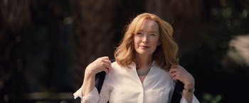 Movie still from “Gifted” (2017), directed by Marc Webb – A woman in a white shirt is holding her hair; Close Up shot, Low angle