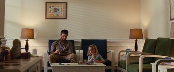 Movie still from “Gifted” (2017), directed by Marc Webb – A man and a woman sitting in a room; Wide shot, Low angle