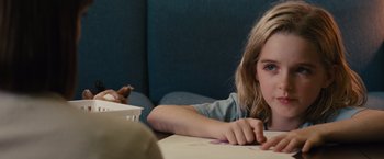Movie still from “Gifted” (2017), directed by Marc Webb – A little girl sitting at a table drawing; Close Up shot, Over the shoulder angle