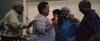 Movie still from “Gifted” (2017), directed by Marc Webb – A group of people standing next to each other; Medium shot, Low angle