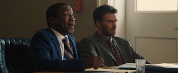 Movie still from “Gifted” (2017), directed by Marc Webb – Two men in suits sitting at a table; Close Up shot, Over the shoulder angle