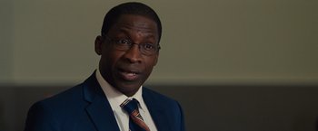 Movie still from “Gifted” (2017), directed by Marc Webb – A person wearing a suit and tie; Close Up shot, Over the shoulder angle