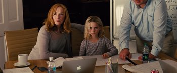 Movie still from “Gifted” (2017), directed by Marc Webb – A woman and a girl sitting at a table with an open laptop; Medium shot, Over the shoulder angle