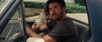 Movie still from “Gifted” (2017), directed by Marc Webb – A man sitting in the back of a car with two other people; Close Up shot, Over the shoulder angle
