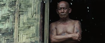 Movie still from “Gold” (2016), directed by Stephen Gaghan – An older man standing next to an open door; Close Up shot, Low angle