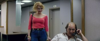 Movie still from “Gold” (2016), directed by Stephen Gaghan – A woman standing next to a man in a room; Medium shot, Low angle