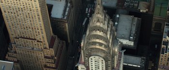 Movie still from “Gold” (2016), directed by Stephen Gaghan – An aerial view of a building in the middle of a city; Extreme Wide shot, Overhead angle