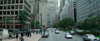 Movie still from “Gold” (2016), directed by Stephen Gaghan – A city street with cars and people on the sidewalk; Extreme Wide shot, High angle