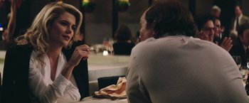 Movie still from “Gold” (2016), directed by Stephen Gaghan – Two people sitting at a table in front of a plate of food; Close Up shot, Over the shoulder angle