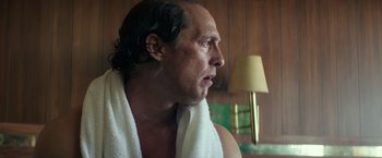Movie still from “Gold” (2016), directed by Stephen Gaghan – A person wearing a towel; Close Up shot, Over the shoulder angle