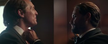 Movie still from “Gold” (2016), directed by Stephen Gaghan – Two men are facing each other in a dark room; Close Up shot, Over the shoulder angle