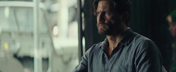 Movie still from “Gold” (2016), directed by Stephen Gaghan – A person wearing a shirt; Close Up shot, Over the shoulder angle