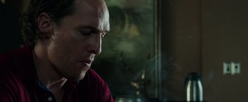 Movie still from “Gold” (2016), directed by Stephen Gaghan – A man with a bald head is smoking a cigarette; Close Up shot, Low angle