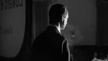 Movie still from “Good Night, and Good Luck.” (2005), directed by George Clooney – A black and white photo of a man in a suit; Close Up shot, Low angle