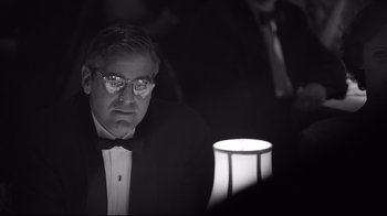 Movie still from “Good Night, and Good Luck.” (2005), directed by George Clooney – A black and white photo of a man in a tuxedo; Close Up shot, Over the shoulder angle