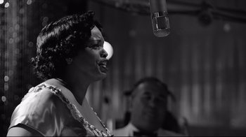 Movie still from “Good Night, and Good Luck.” (2005), directed by George Clooney – A woman singing in front of a microphone; Close Up shot, Low angle