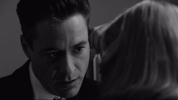 Movie still from “Good Night, and Good Luck.” (2005), directed by George Clooney – A black - and - white photo of a man and a woman; Close Up shot, Over the shoulder angle