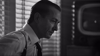 Movie still from “Good Night, and Good Luck.” (2005), directed by George Clooney – Black and white photograph of a man in a suit and tie; Close Up shot, Over the shoulder angle