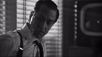 Movie still from “Good Night, and Good Luck.” (2005), directed by George Clooney – Black and white photograph of a man in a tie; Close Up shot, Low angle