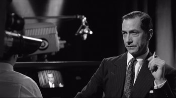 Movie still from “Good Night, and Good Luck.” (2005), directed by George Clooney – Black and white photograph of a man in a suit; Close Up shot, Over the shoulder angle