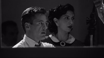 Movie still from “Good Night, and Good Luck.” (2005), directed by George Clooney – A man and a woman are sitting next to each other in front of a computer screen; Close Up shot, Low angle