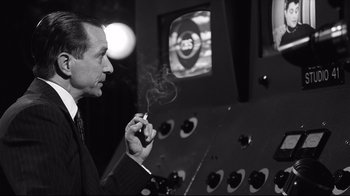 Movie still from “Good Night, and Good Luck.” (2005), directed by George Clooney – A black and white photo of a man smoking a cigarette; Close Up shot, Over the shoulder angle