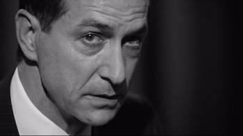 Movie still from “Good Night, and Good Luck.” (2005), directed by George Clooney – Black and white photograph of a man looking at camera; Close Up shot, Low angle