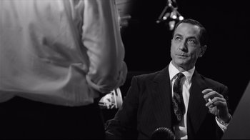 Movie still from “Good Night, and Good Luck.” (2005), directed by George Clooney – A man in a suit and a tie; Close Up shot, Over the shoulder angle