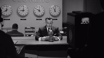 Movie still from “Good Night, and Good Luck.” (2005), directed by George Clooney – A black and white photo of a man sitting at a desk; Medium shot, Low angle