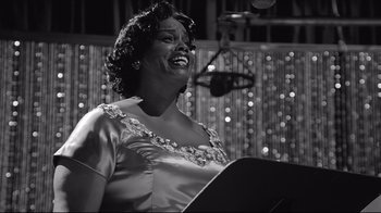 Movie still from “Good Night, and Good Luck.” (2005), directed by George Clooney – A black and white photo of a woman singing; Close Up shot, Low angle