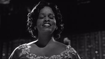 Movie still from “Good Night, and Good Luck.” (2005), directed by George Clooney – A black and white photo of a woman smiling; Close Up shot, Low angle