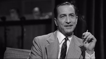 Movie still from “Good Night, and Good Luck.” (2005), directed by George Clooney – An older man wearing a suit and tie; Close Up shot, Over the shoulder angle