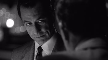 Movie still from “Good Night, and Good Luck.” (2005), directed by George Clooney – Black and white photograph of a man in a suit; Close Up shot, Over the shoulder angle
