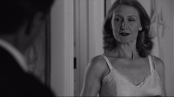Movie still from “Good Night, and Good Luck.” (2005), directed by George Clooney – A black and white photo of a woman in a white dress; Close Up shot, Over the shoulder angle