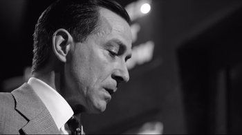 Movie still from “Good Night, and Good Luck.” (2005), directed by George Clooney – Black and white photograph of a man looking down; Close Up shot, Low angle