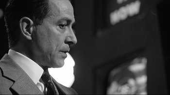 Movie still from “Good Night, and Good Luck.” (2005), directed by George Clooney – Black and white photograph of a man in a suit; Close Up shot, Low angle
