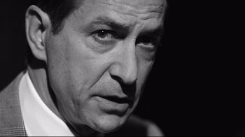 Movie still from “Good Night, and Good Luck.” (2005), directed by George Clooney – Black and white photograph of a man in a white dress shirt; Close Up shot, Low angle