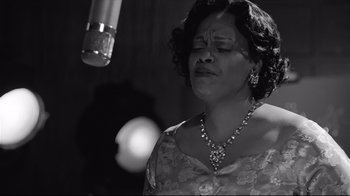 Movie still from “Good Night, and Good Luck.” (2005), directed by George Clooney – A black and white photo of a woman singing; Close Up shot, Low angle