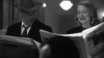 Movie still from “Good Night, and Good Luck.” (2005), directed by George Clooney – A man and a woman are reading a newspaper together; Close Up shot, Over the shoulder angle