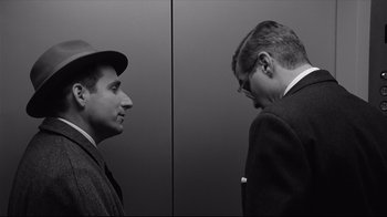 Movie still from “Good Night, and Good Luck.” (2005), directed by George Clooney – Two men standing next to each other in front of a wall; Close Up shot, Low angle