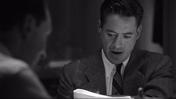 Movie still from “Good Night, and Good Luck.” (2005), directed by George Clooney – A black and white photo of a man in a suit and tie; Close Up shot, Over the shoulder angle
