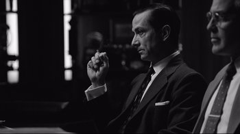 Movie still from “Good Night, and Good Luck.” (2005), directed by George Clooney – Black and white photograph of a man smoking a cigarette; Close Up shot, Over the shoulder angle