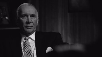 Movie still from “Good Night, and Good Luck.” (2005), directed by George Clooney – An older man wearing a suit and tie; Close Up shot, Over the shoulder angle