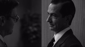 Movie still from “Good Night, and Good Luck.” (2005), directed by George Clooney – Black and white photograph of a man in a suit; Close Up shot, Over the shoulder angle