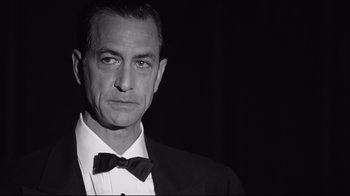 Movie still from “Good Night, and Good Luck.” (2005), directed by George Clooney – Black and white photograph of a man in a tuxedo; Close Up shot, Low angle