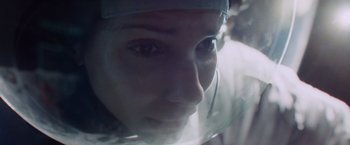 Movie still from “Gravity” (2013), directed by Alfonso Cuarón – A person wearing a face shield; Close Up shot, Overhead angle