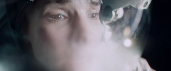 Movie still from “Gravity” (2013), directed by Alfonso Cuarón – A person's eyes with smoke coming out of them; Extreme Close Up shot, Overhead angle