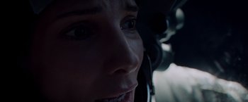 Movie still from “Gravity” (2013), directed by Alfonso Cuarón – A woman's face with a headset on; Close Up shot, Overhead angle