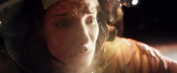 Movie still from “Gravity” (2013), directed by Alfonso Cuarón – A person wearing a helmet; Close Up shot, Overhead angle