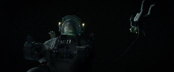 Movie still from “Gravity” (2013), directed by Alfonso Cuarón – A man in a spacesuit is looking into the distance; Wide shot, Overhead angle